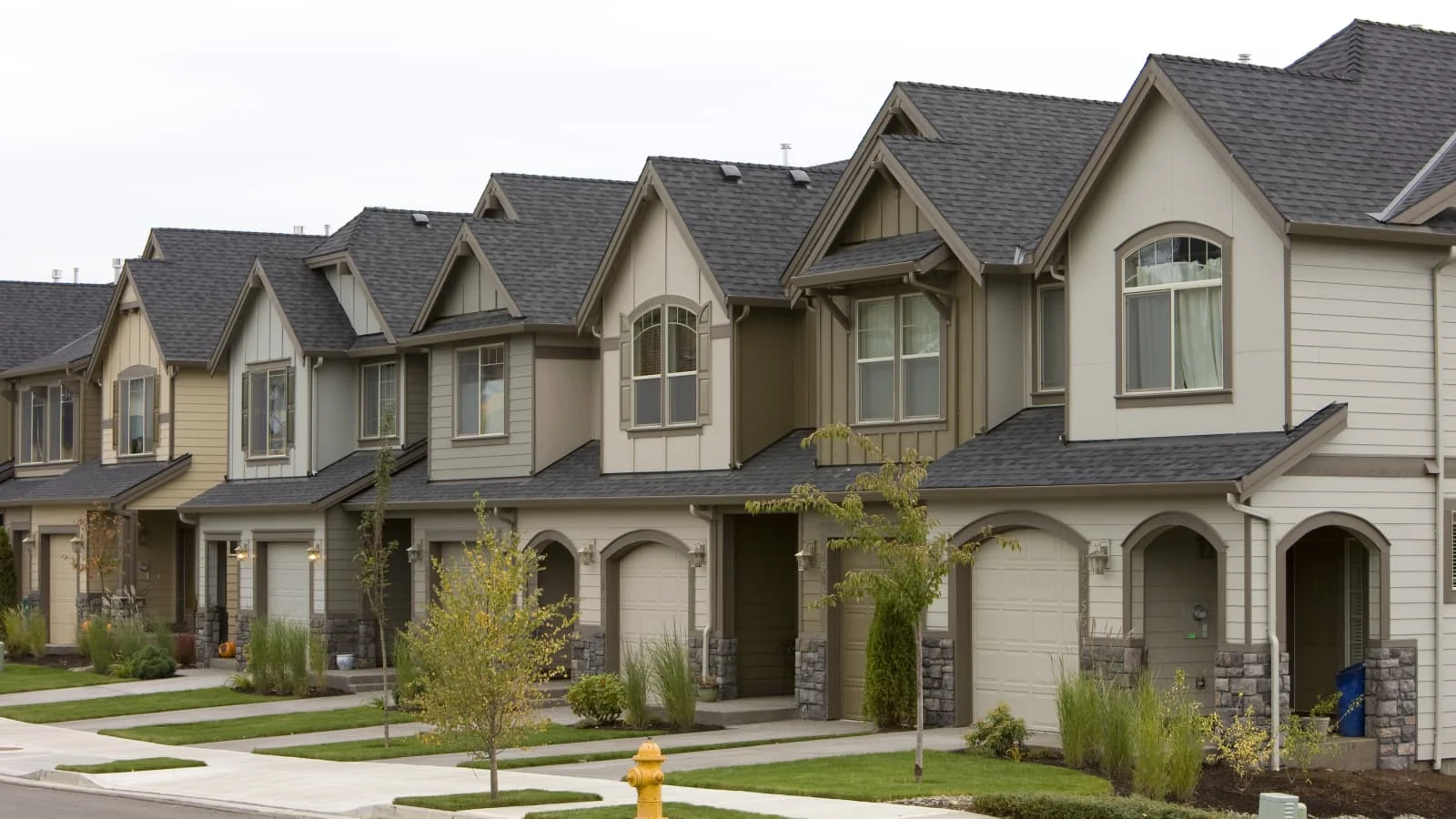 Millennial Homeownership Reaches Crisis Level as Median Home Hits $398,000 Young couple looking at a house with a for sale sign in the yard